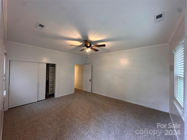 unfurnished bedroom with ceiling fan, a closet, and carpet