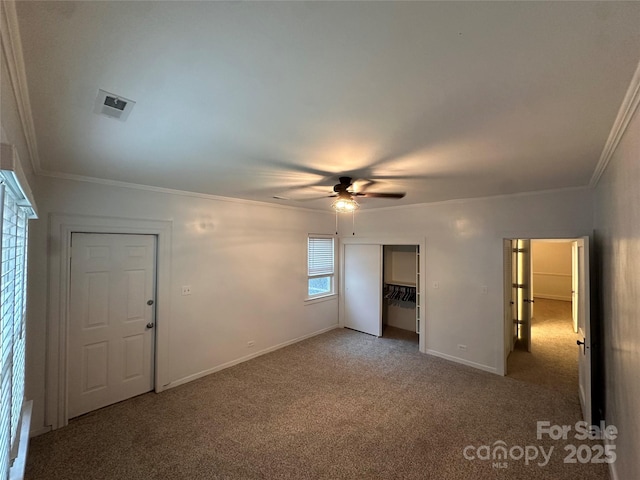 unfurnished bedroom with visible vents, crown molding, baseboards, light carpet, and a closet