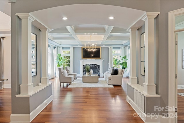 unfurnished room featuring coffered ceiling, dark hardwood / wood-style floors, and plenty of natural light