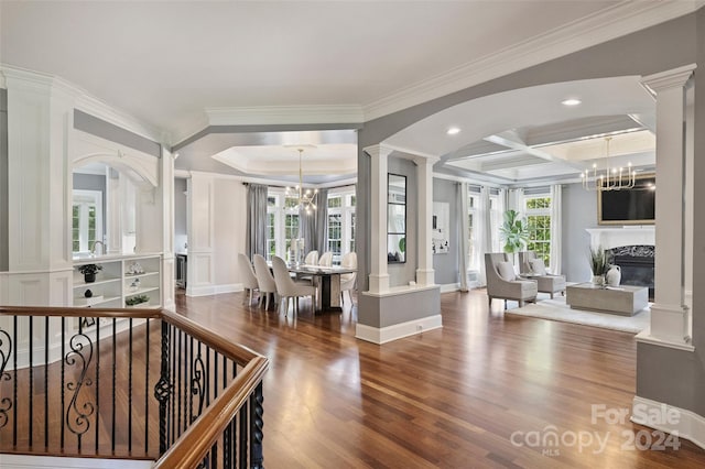 interior space with coffered ceiling, crown molding, dark hardwood / wood-style flooring, and a chandelier