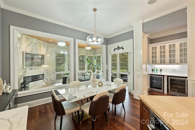 dining area with crown molding, beverage cooler, and dark wood-type flooring