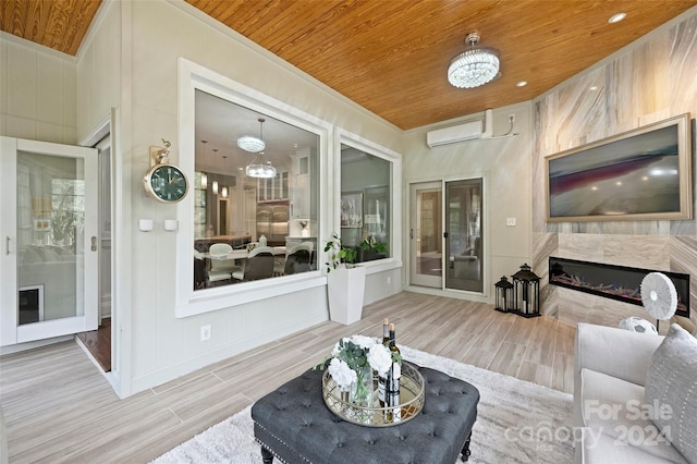 living room with wood ceiling, light hardwood / wood-style floors, a high end fireplace, and a wall mounted AC