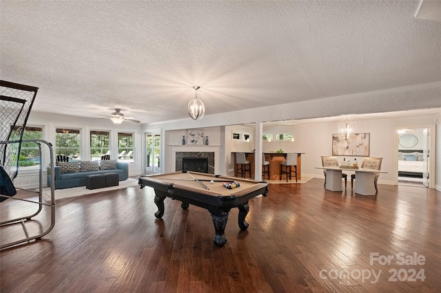 game room with pool table, a textured ceiling, ceiling fan, and dark hardwood / wood-style flooring