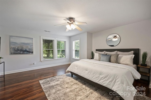 bedroom with ceiling fan and dark hardwood / wood-style floors