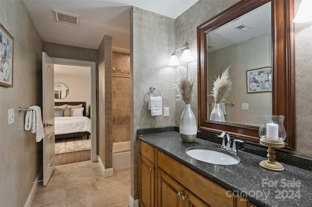 bathroom featuring tile patterned floors, a shower, and vanity