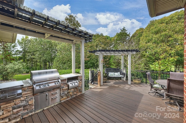 deck with area for grilling, grilling area, and a pergola