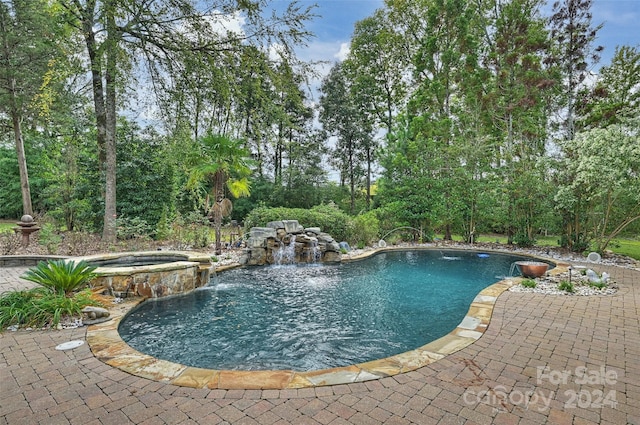 view of swimming pool with a patio area, an in ground hot tub, and pool water feature