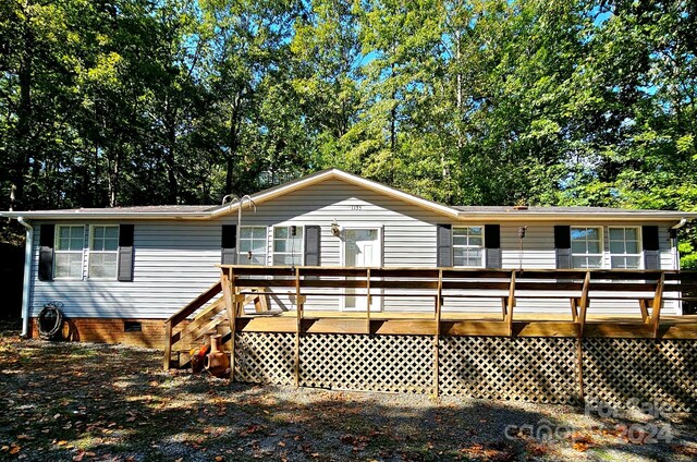 back of house featuring a wooden deck