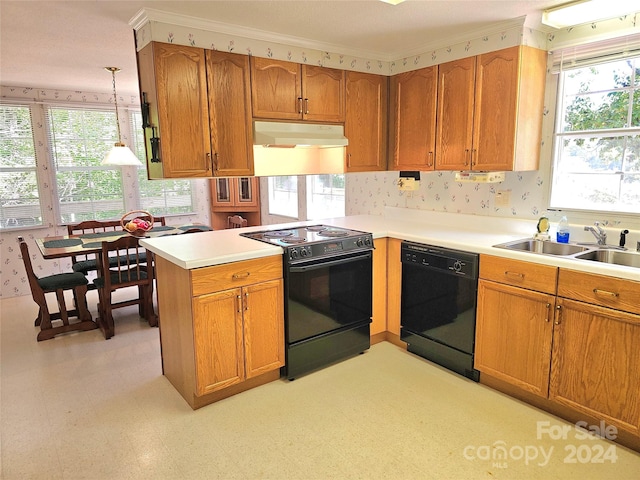 kitchen with hanging light fixtures, kitchen peninsula, black appliances, a healthy amount of sunlight, and sink