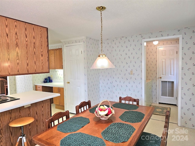 tiled dining area featuring a textured ceiling