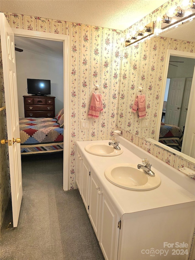 bathroom featuring a textured ceiling and vanity