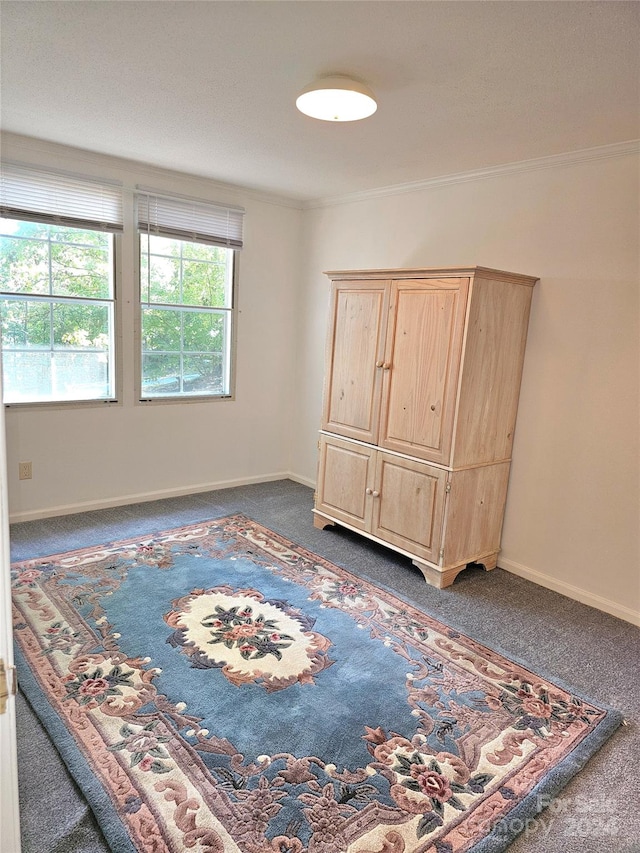 unfurnished bedroom with dark carpet and ornamental molding