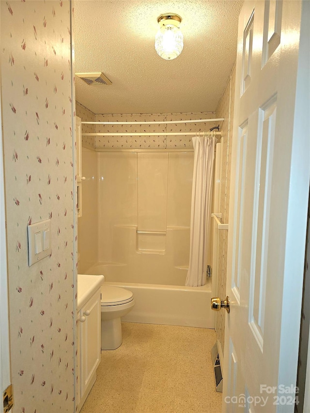 full bathroom featuring shower / tub combo, a textured ceiling, vanity, and toilet