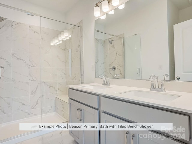 bathroom featuring a tile shower and vanity