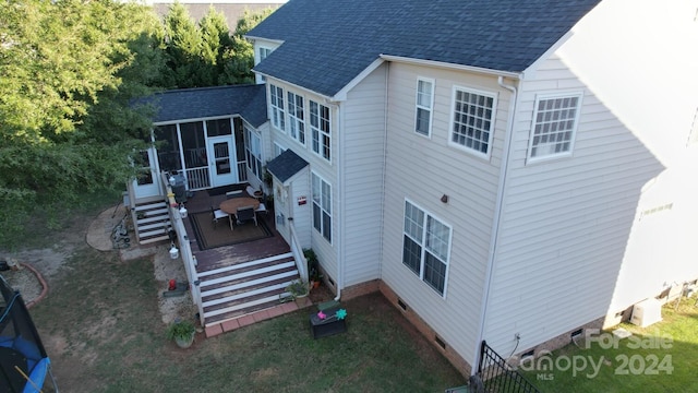 back of house featuring a deck and a sunroom