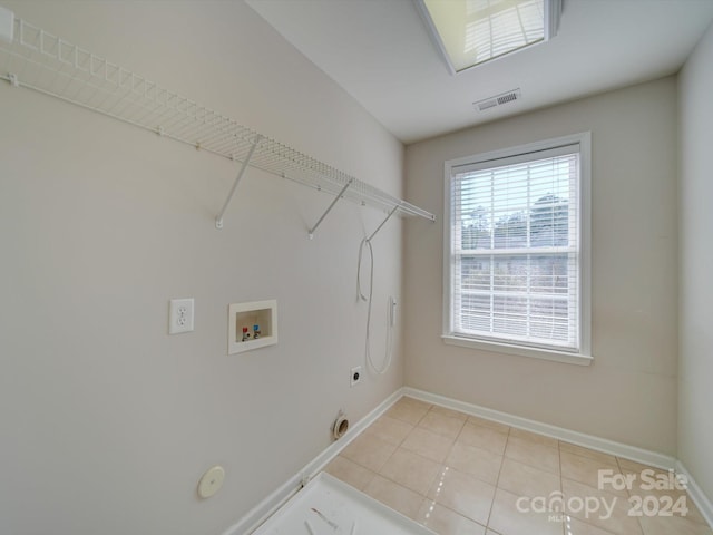 laundry room featuring hookup for an electric dryer, hookup for a washing machine, hookup for a gas dryer, and light tile patterned floors