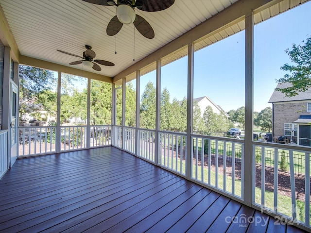 unfurnished sunroom featuring a healthy amount of sunlight and ceiling fan