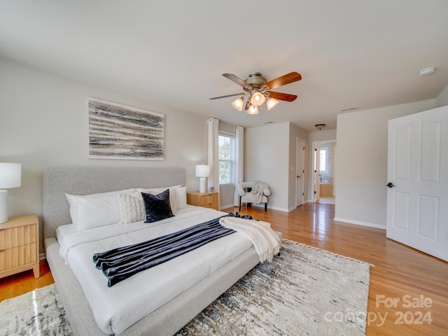 bedroom with light wood-type flooring and ceiling fan