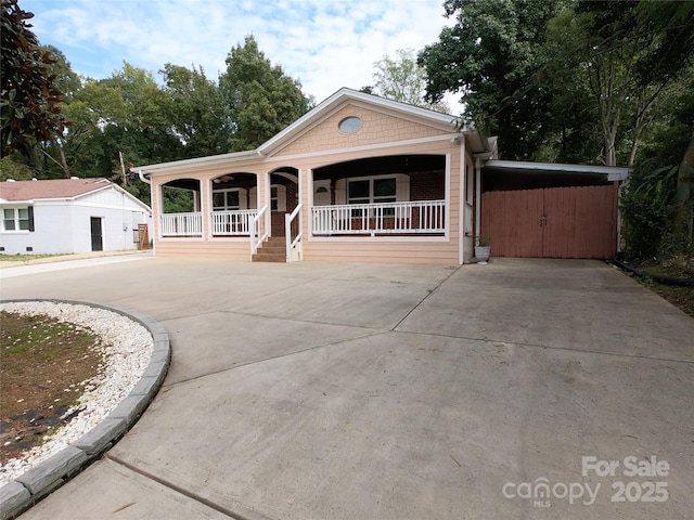 view of front of house featuring covered porch and a carport