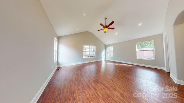 unfurnished room with ceiling fan, dark wood-type flooring, and lofted ceiling