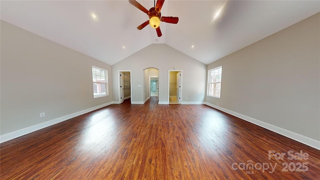 unfurnished living room featuring ceiling fan, dark hardwood / wood-style floors, and vaulted ceiling