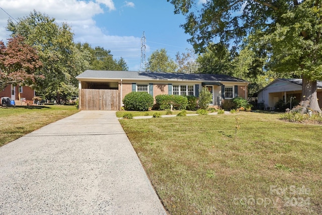 ranch-style home featuring a front yard and a carport