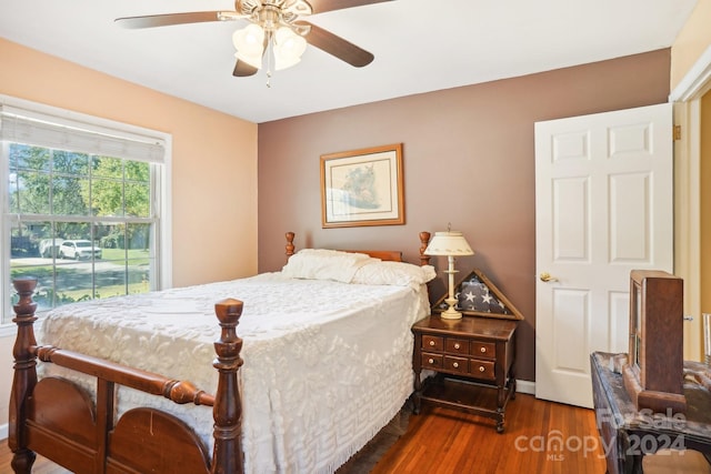 bedroom featuring ceiling fan and dark hardwood / wood-style floors