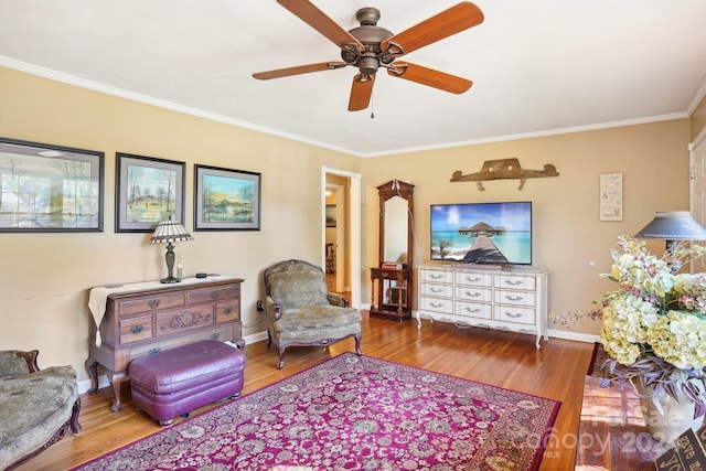 living room featuring ceiling fan, wood-type flooring, and ornamental molding