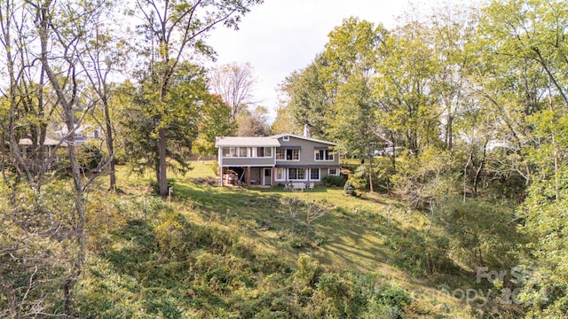 rear view of property featuring a yard