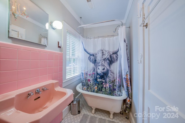 bathroom featuring independent shower and bath, tile walls, crown molding, and tile patterned flooring