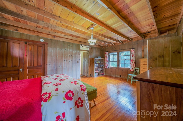 bedroom with wooden ceiling, beamed ceiling, light hardwood / wood-style flooring, and wooden walls