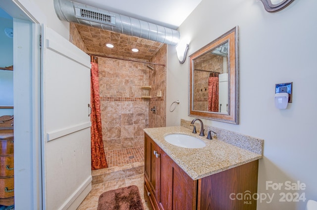 bathroom with vanity, tile patterned floors, and curtained shower