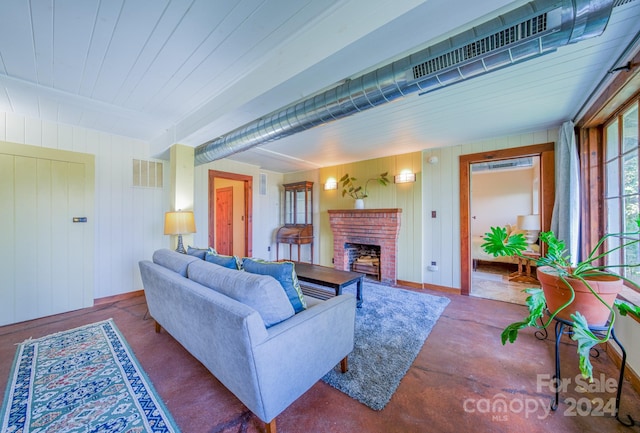 living room with wooden walls and a fireplace