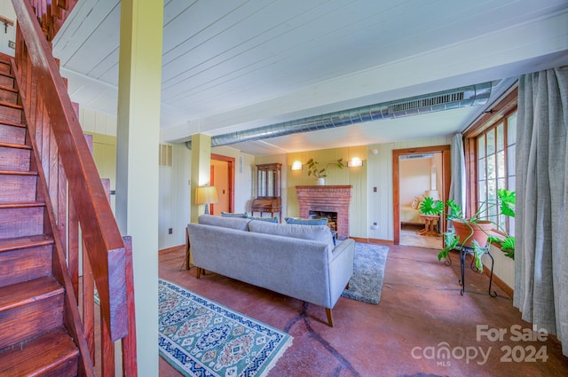 living room featuring a brick fireplace