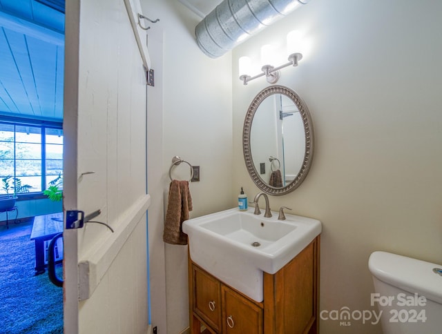 bathroom featuring vanity and toilet