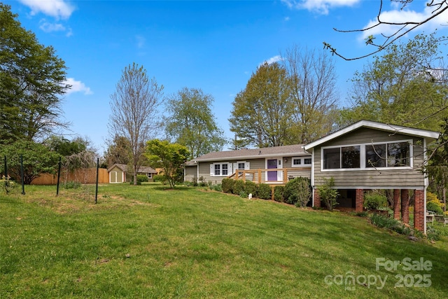 139 Neely Rd, Brevard, NC 28712 - exterior space featuring a shed, a wooden deck, an outbuilding, a lawn, and brick siding