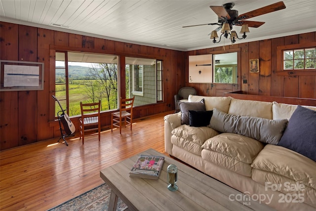 139 Neely Rd, Brevard, NC 28712 - living room with crown molding, wooden walls, a ceiling fan, and a healthy amount of sunlight