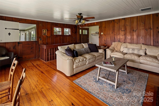 139 Neely Rd, Brevard, NC 28712 - living room featuring wood walls, a ceiling fan, crown molding, and visible vents