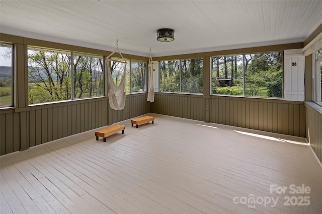 139 Neely Rd, Brevard, NC 28712 - unfurnished sunroom with wood-type flooring, wooden walls, and a wealth of natural light