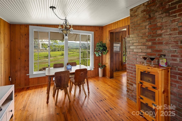 139 Neely Rd, Brevard, NC 28712 - dining area featuring wooden walls, light wood-type flooring, and an inviting chandelier