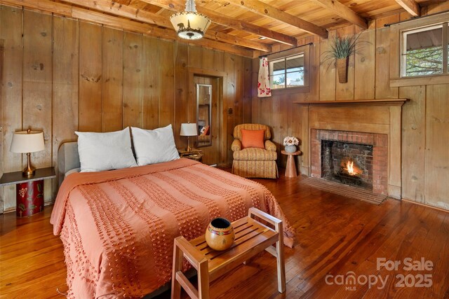 139 Neely Rd, Brevard, NC 28712 - bedroom featuring wood-type flooring, beam ceiling, and wood walls
