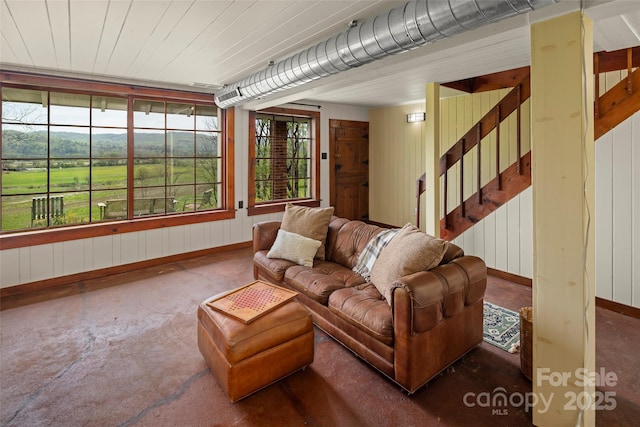 139 Neely Rd, Brevard, NC 28712 - living area with baseboards, wood walls, and stairs