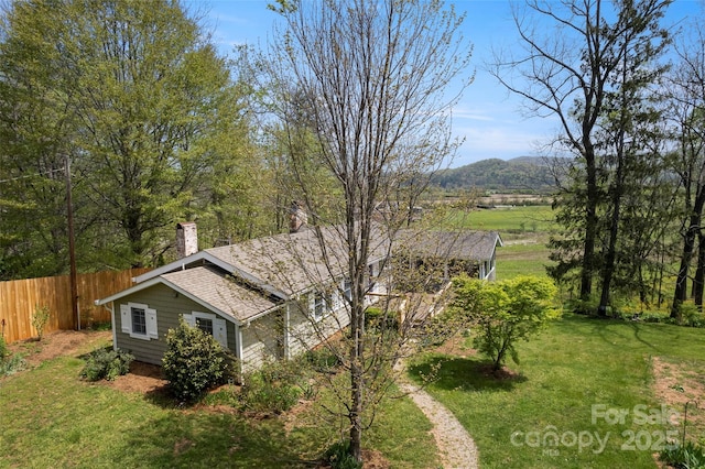 139 Neely Rd, Brevard, NC 28712 - exterior space featuring a chimney, fence, a shingled roof, a yard, and a mountain view