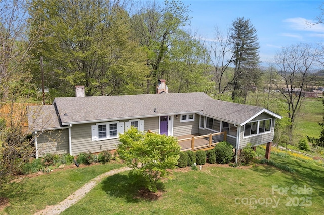 139 Neely Rd, Brevard, NC 28712 - ranch-style home featuring a chimney, roof with shingles, a sunroom, a front yard, and a deck