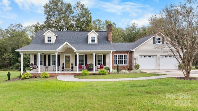 cape cod-style house with a front yard, a garage, and covered porch