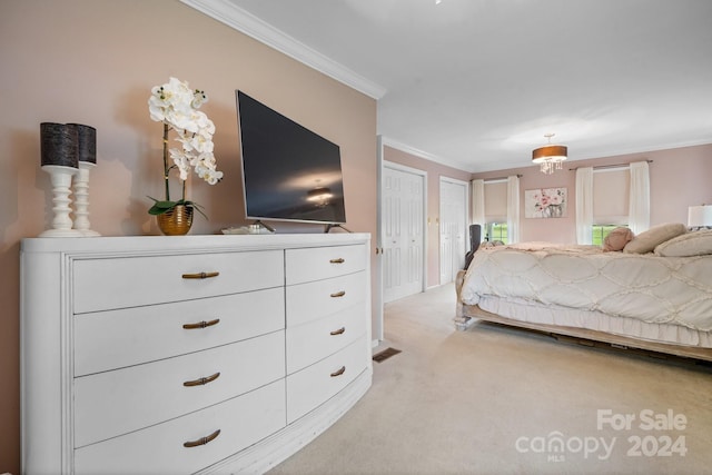 unfurnished bedroom with light carpet, multiple closets, and ornamental molding