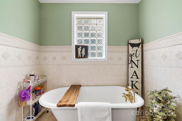 bathroom with a washtub and tile walls