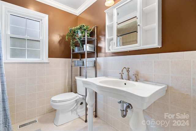 bathroom with a shower with curtain, tile walls, crown molding, and toilet