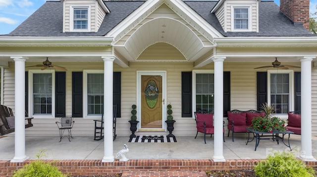 entrance to property featuring ceiling fan and covered porch