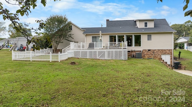 back of property featuring a wooden deck, a lawn, and central air condition unit